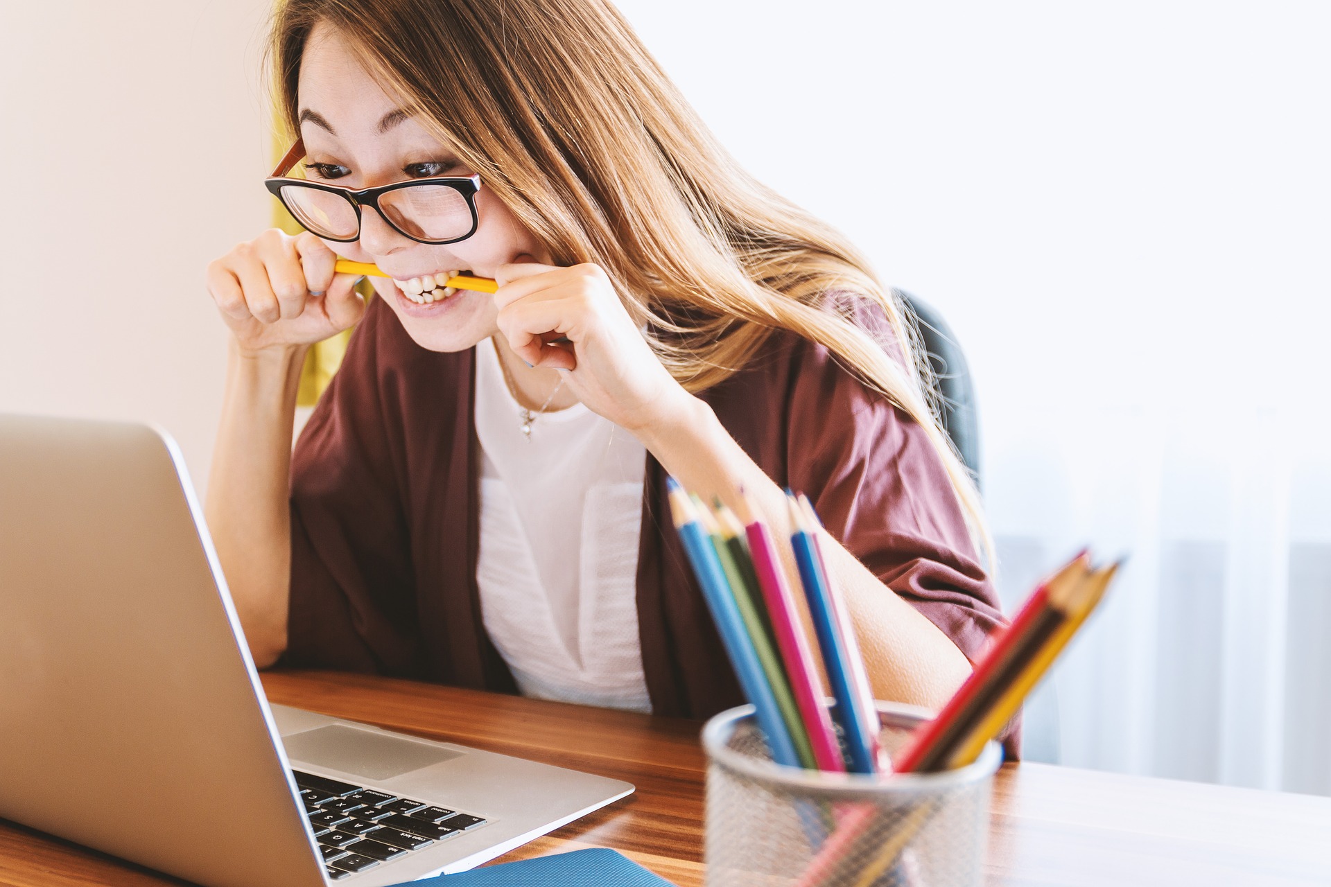 student biting pencil