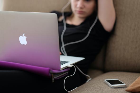 Person using a laptop and phone