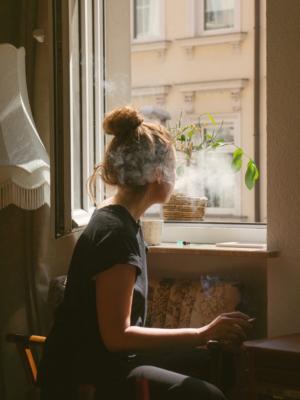 Image of person smoking at home