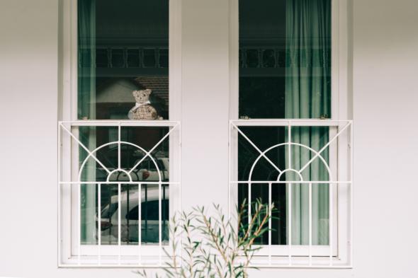 Teddy bear in window