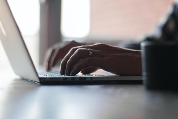 person typing on laptop