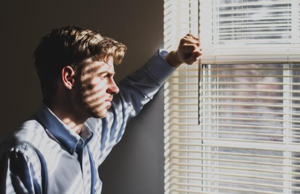 sad man looking out of window