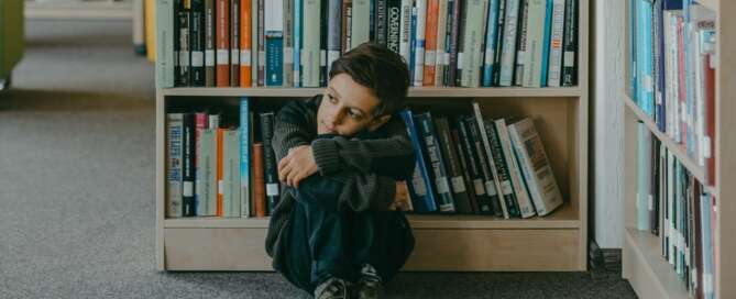 Child alone in library corner