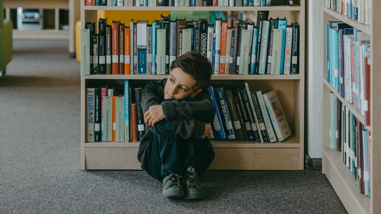 Child alone in library corner