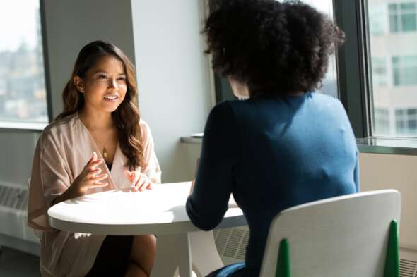 Two people talking at table