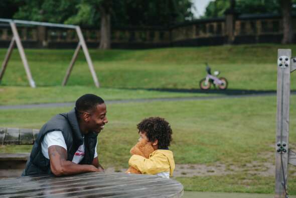 Father son sitting in park
