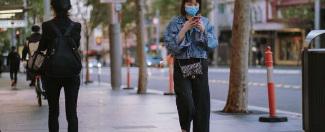 walking on street on phone with face mask