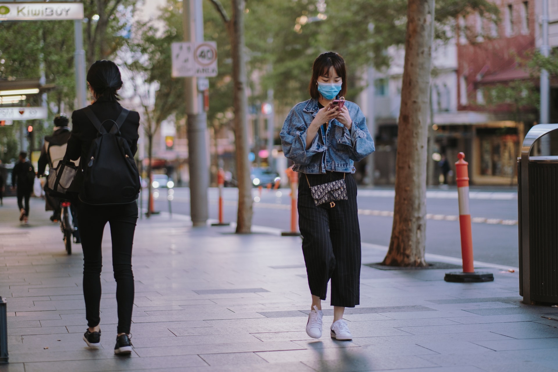 walking on street on phone with face mask