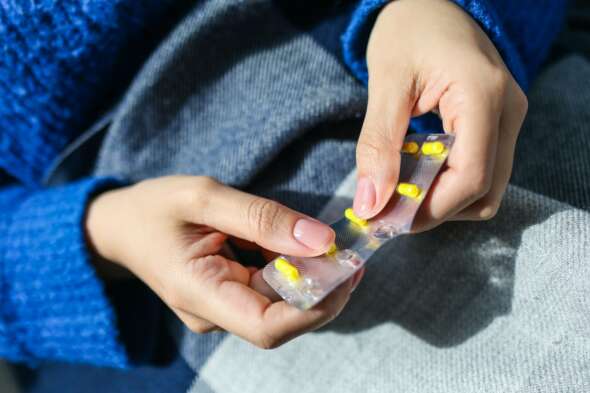 Pill packet in hands
