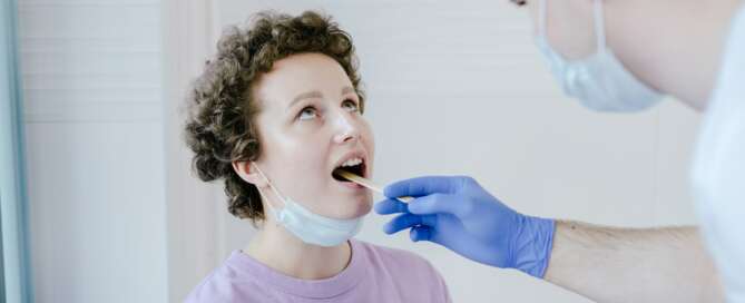 Doctor throat exam on patient