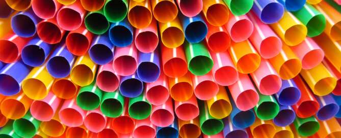 tower of plastic straws in rainbow colours