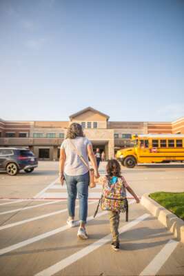 Parent and child going to school