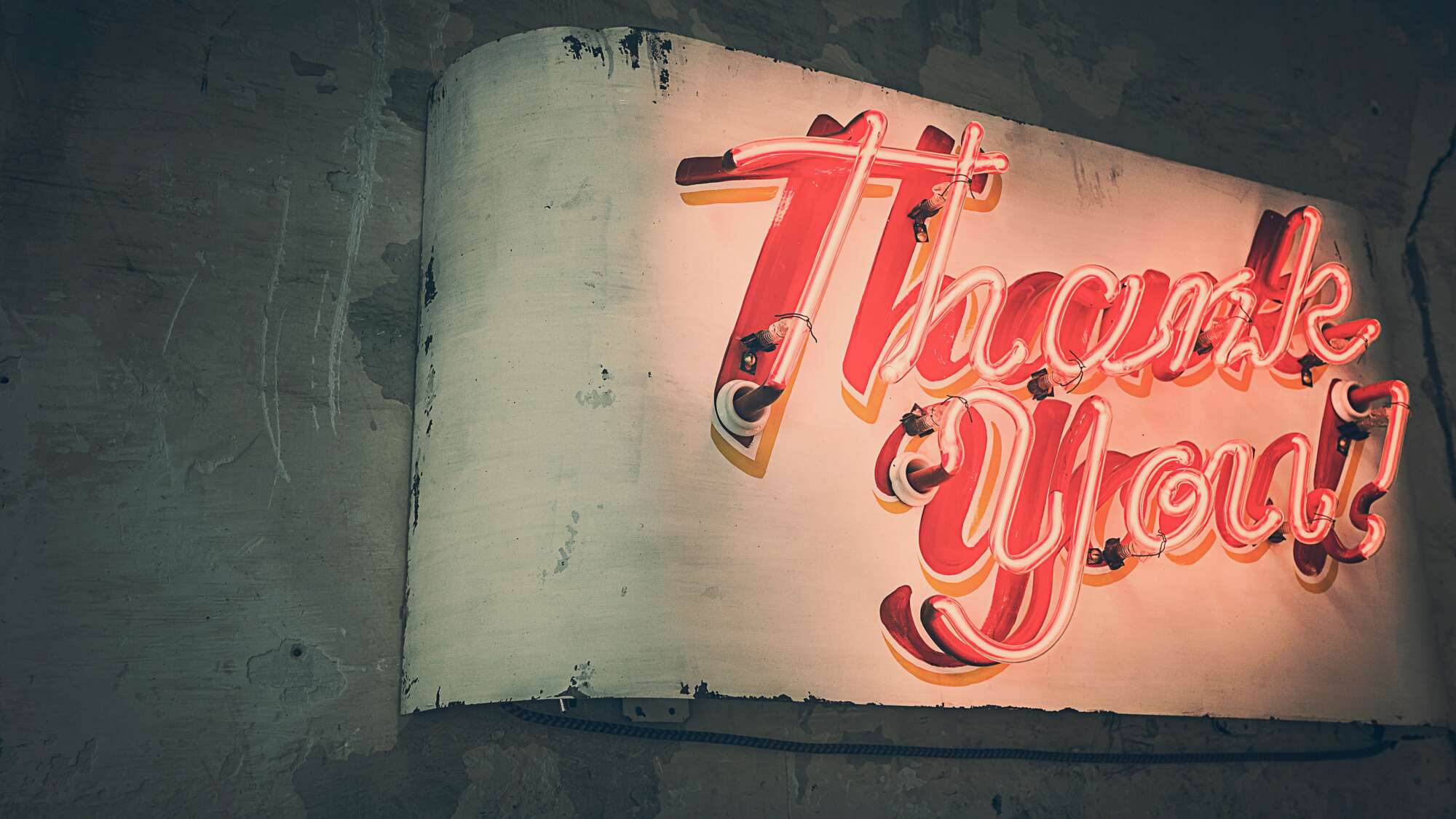 Red LED Thank you sign in a grungy industrial wall