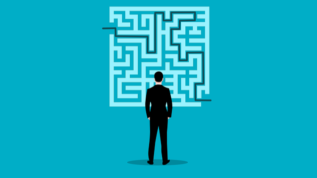 Cartoon man looking at maze graphic with teal background