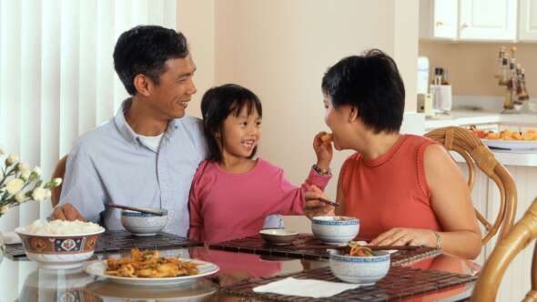 Family eating healthy meal together and happy