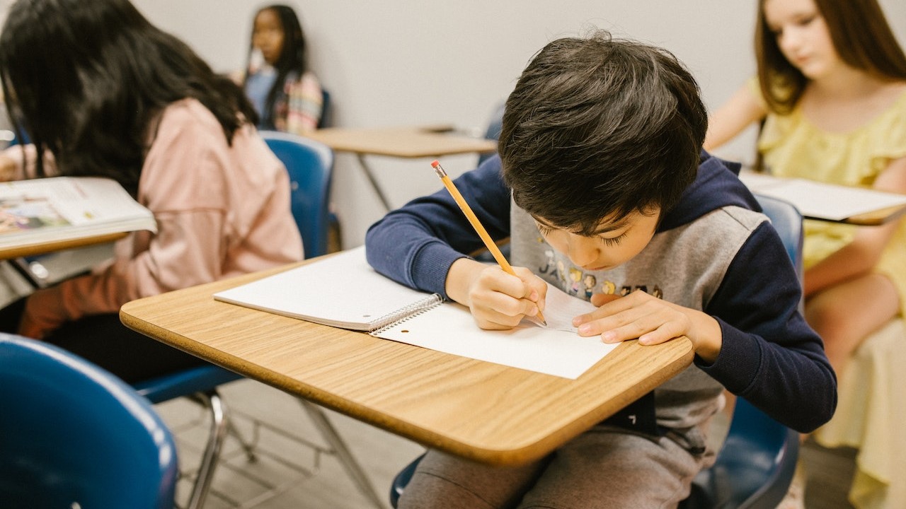 Young boy completing school work in a classroom