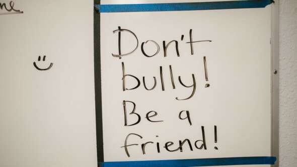 Written on whiteboard: Don't bully! Be a friend!