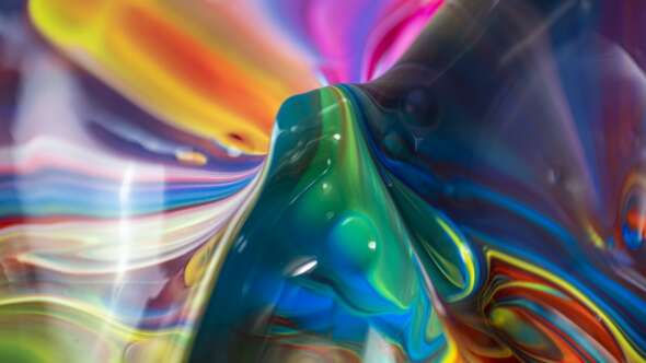 Vibrant paint colours mixing together, pink, orange, blue and green