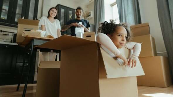Child in a cardboard box being playful